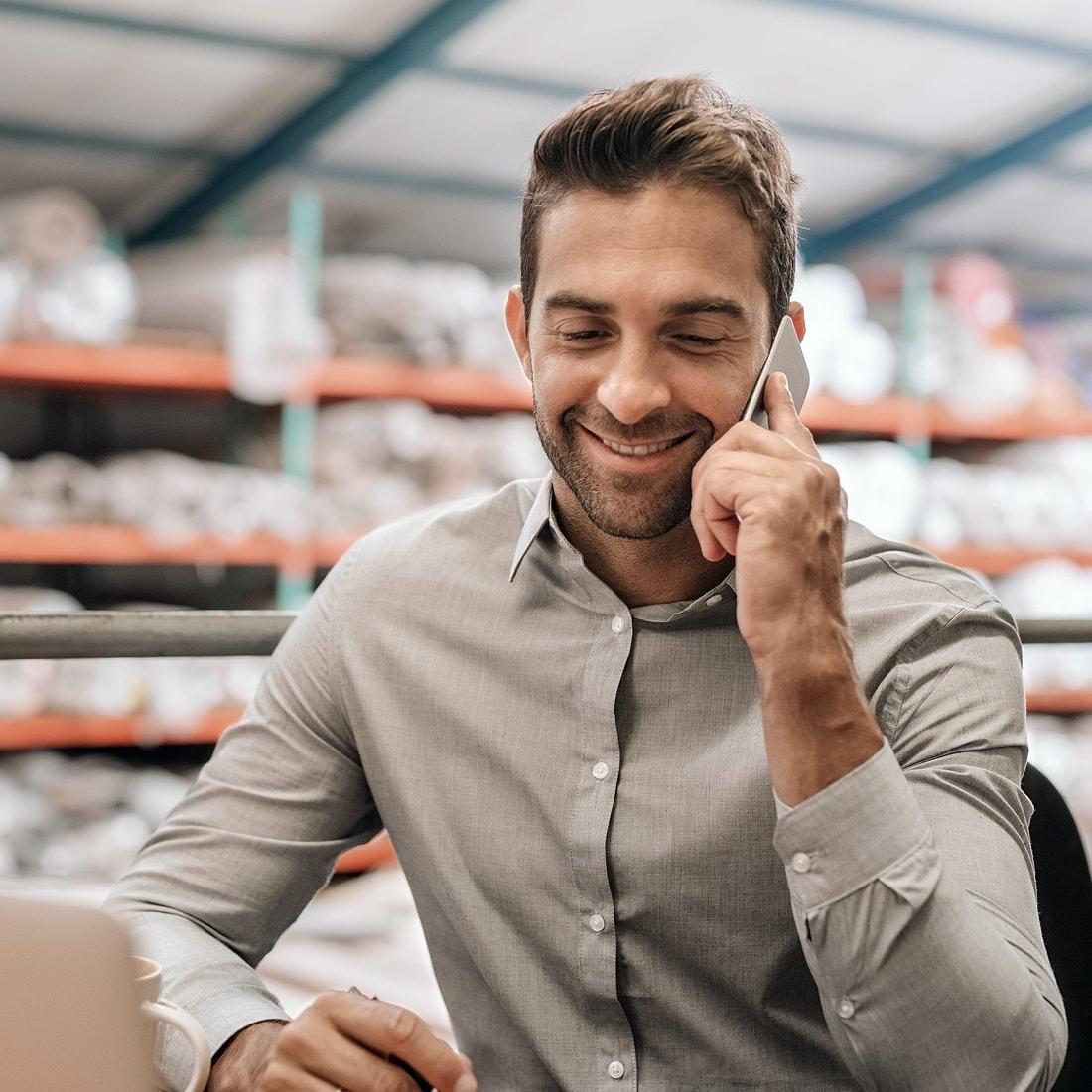 十大最好的网赌平台 owner on phone in warehouse.